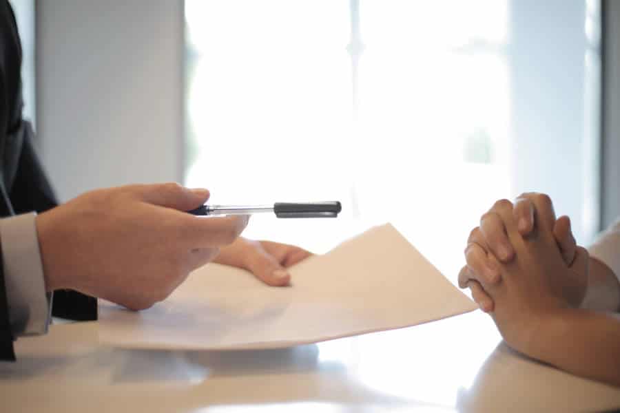 man holding blank paper and pen